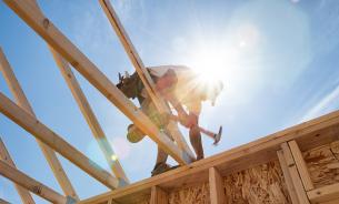 Builder on house roof
